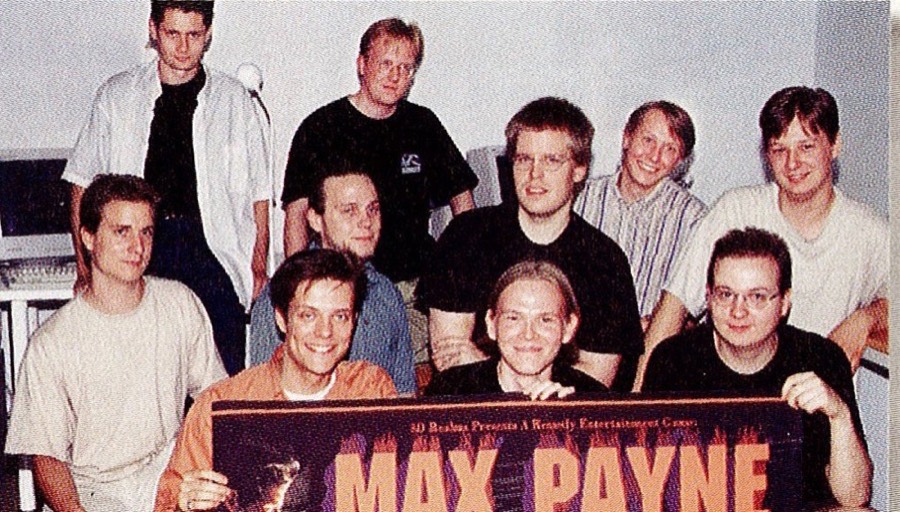 Early Remedy staff holding a Max Payne banner, 1997